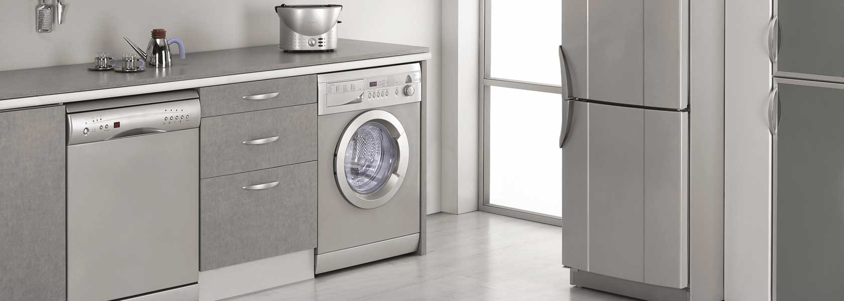 A kitchen with a washing machine under the counter